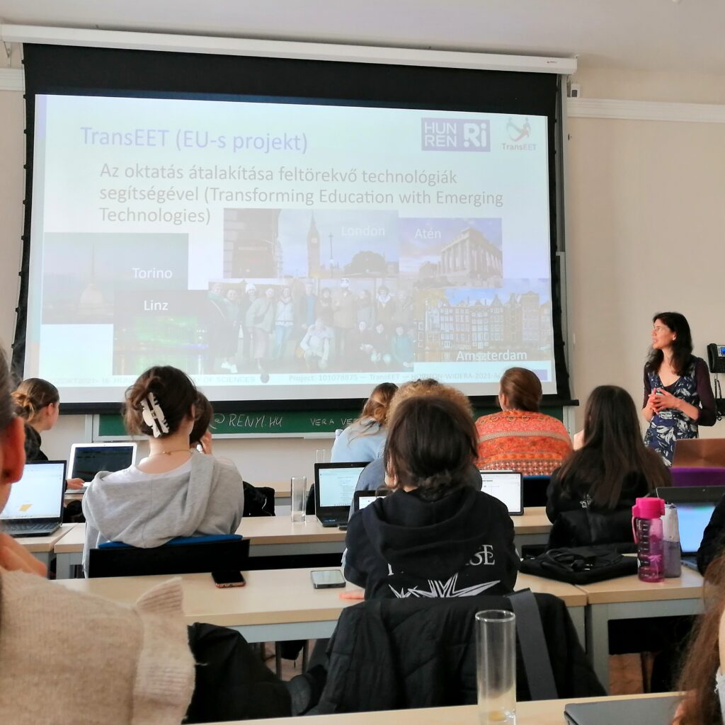 A photo of a researcher presenting a projected slide about the Transeet project to a classroom of girls.