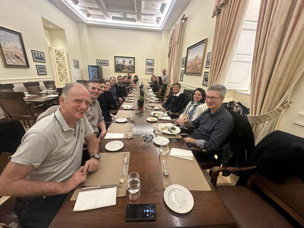 Photo of the Transeet consortium sitting at a long dinner table.