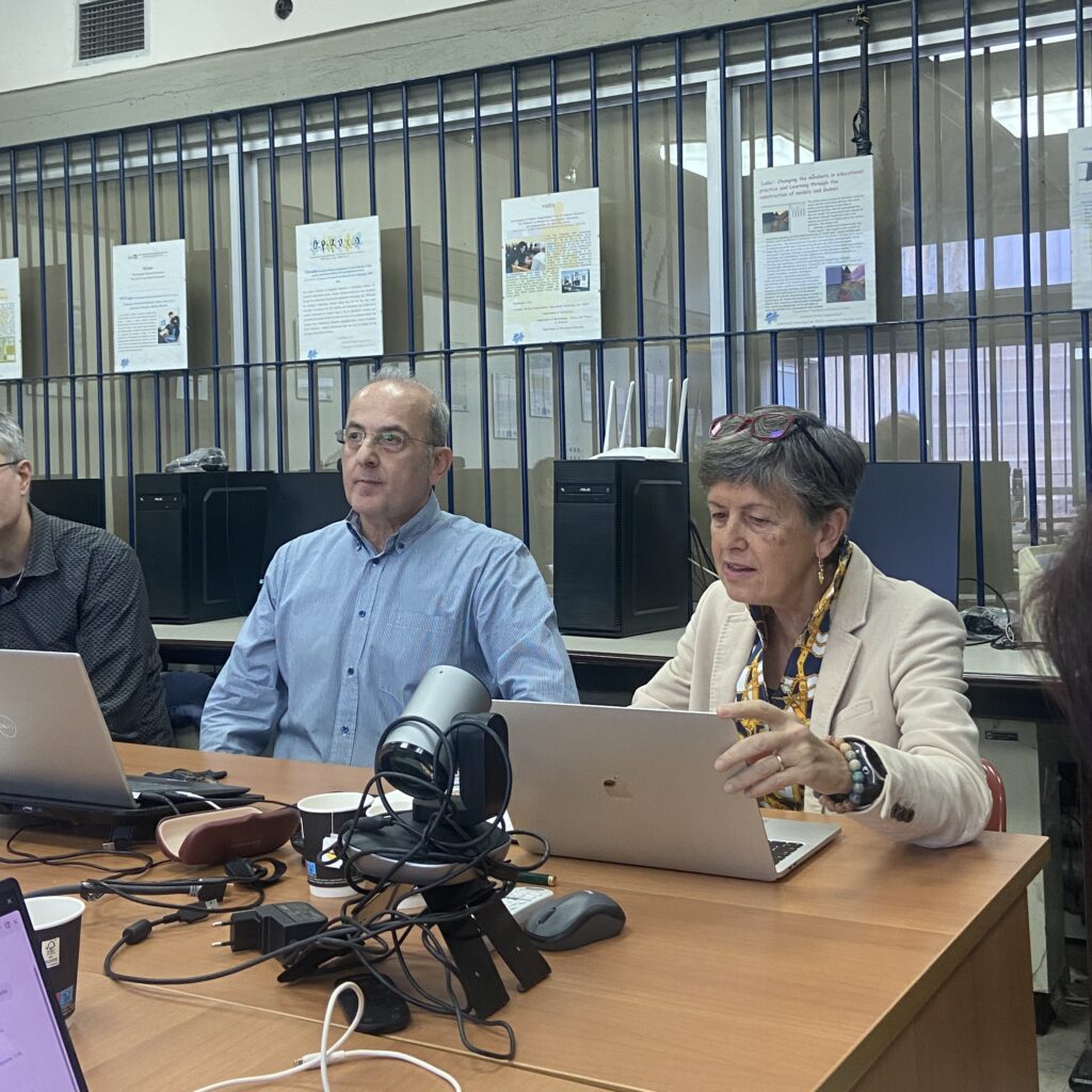 Photo of George Psycharis and Ornella Robutti discussing at a plenary session.